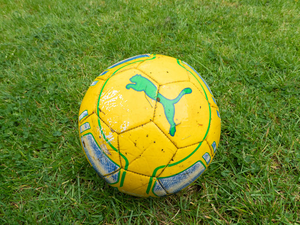 A football sitting on a pitch 